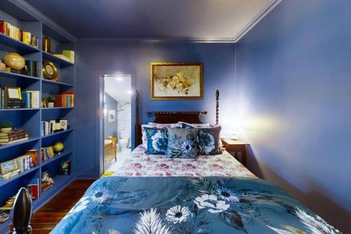 1 dormitorio con 1 cama con pared azul en Blue Haus, en Johnson City