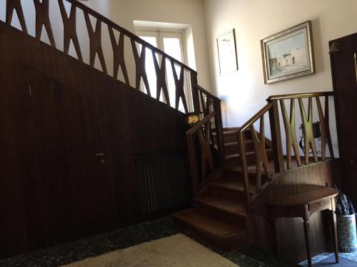 a hallway with a wooden staircase in a house at Il Giardino Nascosto in Busto Arsizio