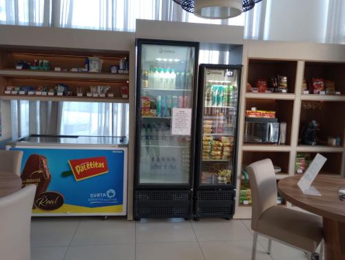 a store with two refrigerators in a restaurant at Quarto com acabamento superior no Design Hotel Linhares in Linhares