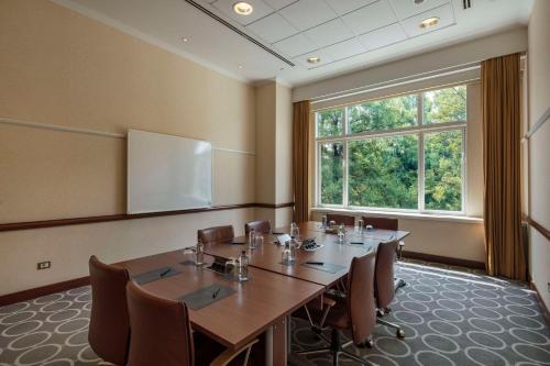 a conference room with a large table and chairs at Adana HiltonSA Hotel in Adana