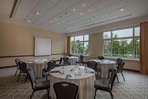 a conference room with tables and chairs and a whiteboard at Adana HiltonSA Hotel in Adana