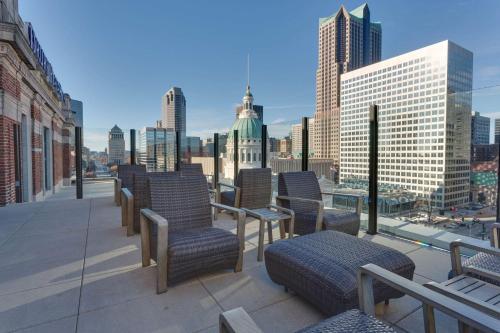 a balcony with chairs and a view of a city at Drury Plaza St. Louis at the Arch in Saint Louis