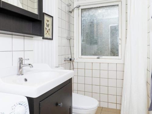 a bathroom with a sink and a toilet and a window at 6 person holiday home in Hals-By Traum in Hals