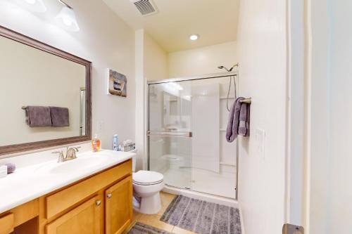 a bathroom with a shower and a sink and a toilet at Golden Marigold Sanctuary in Buckeye
