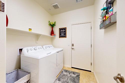 a laundry room with a washer and dryer at Golden Marigold Sanctuary in Buckeye