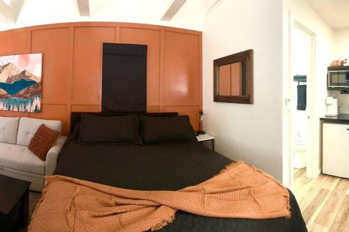 a bedroom with a large bed with an orange headboard at Sand Hollow Zion Mini Home - Pets Welcome 2 with a Fee in Hurricane