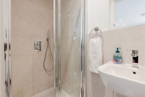 a bathroom with a shower and a sink at 4-Level Luxury 2 Bedroom House Sleeps 6, Rooftop, Harry P & Free Parking in Watford