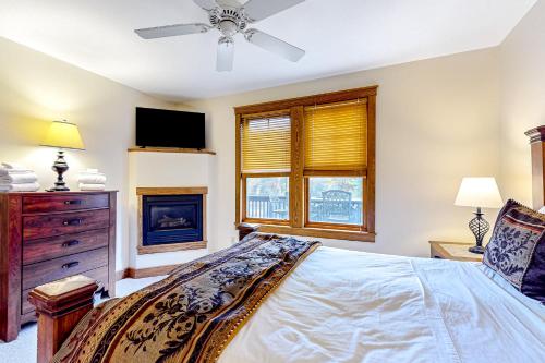 a bedroom with a bed and a tv and a window at Relaxation Ridge in Oakland