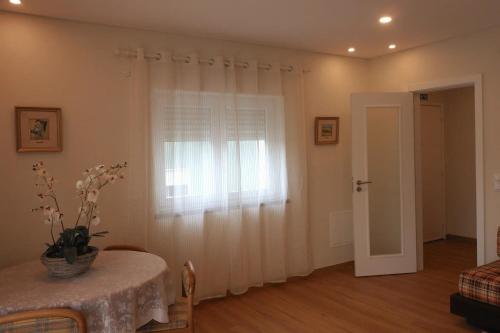 a living room with a table and a window at CascaiSintra Holiday in Alcabideche