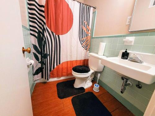 a bathroom with a toilet and a sink at 《~Lovely Home Near Botanical Gardens ~》Pool Table in Memphis