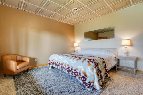 a bedroom with a bed and a chair in it at Spacious Canyon Ferry Lake House with Bar and Views! in Helena
