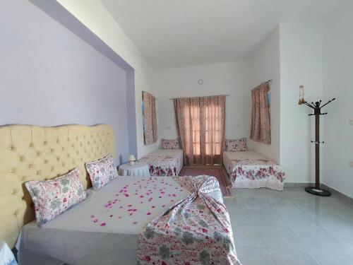 a bedroom with a bed and a cross on the wall at Henchir ejdoud in Kairouan