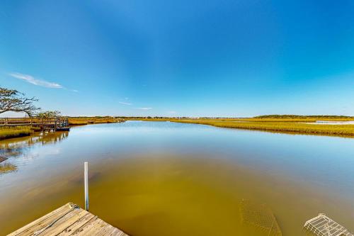 a body of water with a dock in the middle at A Place Between the River and Sea in North Topsail Beach