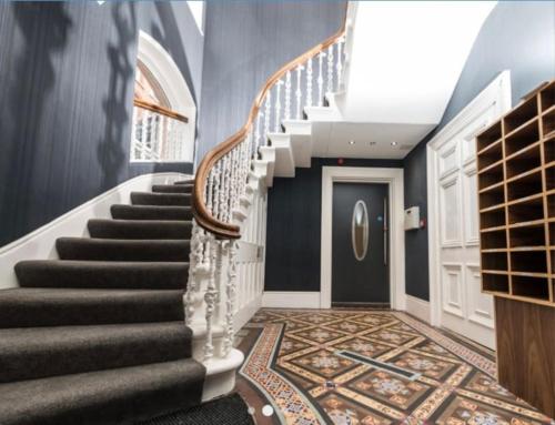 a staircase in a home with blue walls at Flat in Nottingham City Centre in Nottingham