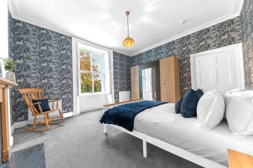 a bedroom with a bed and a chair at 8 Corkickle in Whitehaven