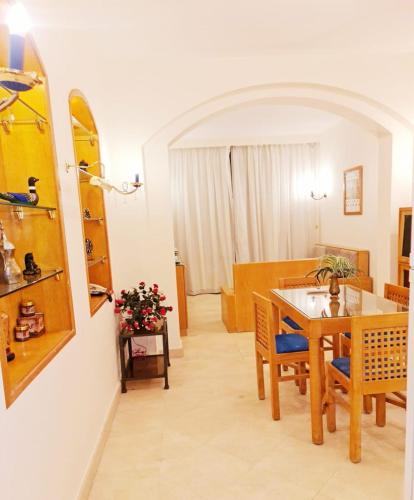 a kitchen and dining room with a table and chairs at West golf 2bedroom in Hurghada