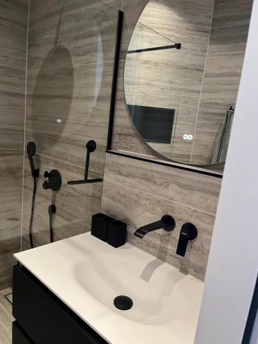 a bathroom with a sink and a mirror at B&B Urban Oasis with Free Parking in Amsterdam