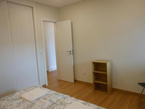 an empty bedroom with a bed and a closet at CascaiSintra Holiday in Alcabideche