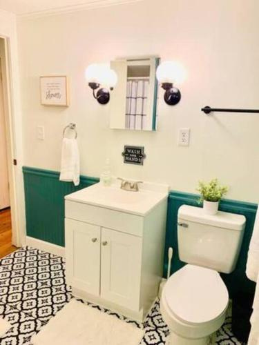 a bathroom with a white toilet and a sink at Peoria Speedway Rocky Glen Bradley Park 4bdrm Home in West Peoria