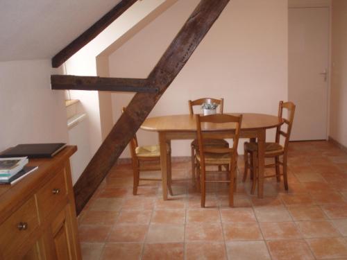 a dining room with a wooden table and chairs at Chambres D'Hôtes De Froulay in Couesmes-vauce