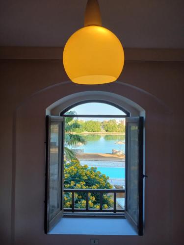 a window in a room with a view of a lake at West golf 2bedroom in Hurghada