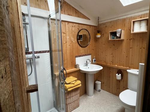 a bathroom with a shower and a sink at Off the Beaten Shack in North Hill