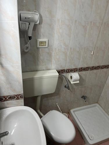 a bathroom with a white toilet and a sink at ~Villa Gloria~ in Durrës
