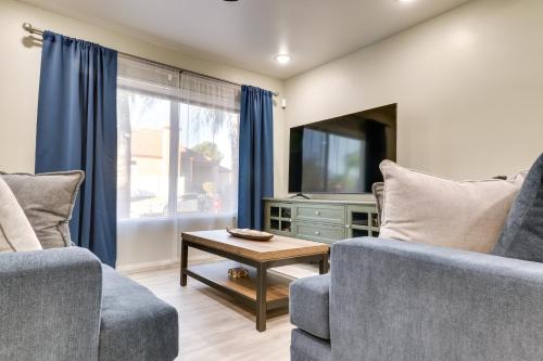 a living room with two chairs and a tv at Conveniently Located Fontana Apartment! in Fontana