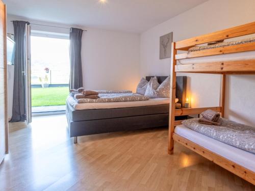 a bedroom with two bunk beds and a window at Josef in Helfenstein