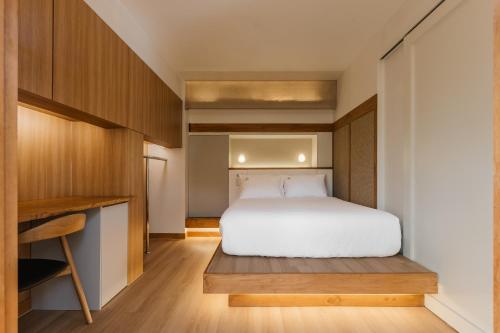 a small bedroom with a bed and a desk at Luxury hanok with private bathtub - SN06 in Seoul