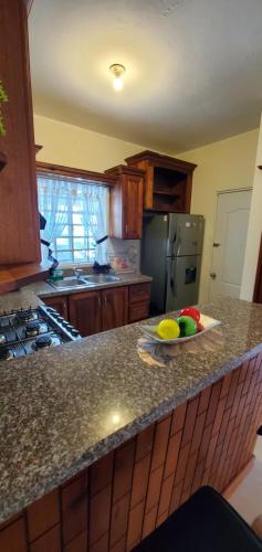 a kitchen with a bowl of fruit on a counter at Pine Tree Entire House 2B Gated Com in Higuey