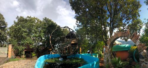 a playground with a roller coaster in a park at El Encinal de las Flores in Valle de Bravo