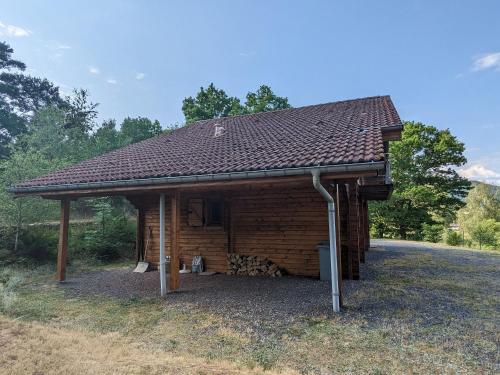 a small building with a roof on top of it at Chalet confortable avec cheminée à Taintrux - FR-1-589-222 in Taintrux