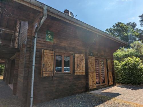 a building with wooden shutters on the side of it at Chalet confortable avec cheminée à Taintrux - FR-1-589-222 in Taintrux
