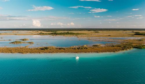 an aerial view of a river with a boat in it at Hotel Boutique Aurea in Bacalar