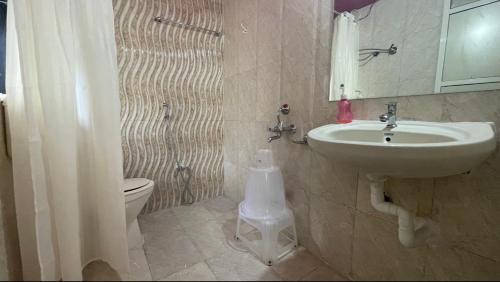 a bathroom with a sink and a toilet at Perfect Couple Bedroom in Panchgani