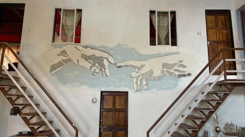 a painting on the side of a building with stairs at Perfect Couple Bedroom in Panchgani