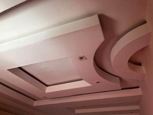 un soffitto a cassettoni in una camera rosa di Lindsey House a Saint-Louis