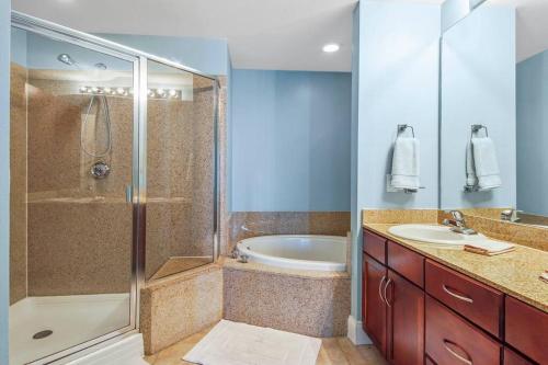 a bathroom with a shower and a sink and a tub at Laketown Wharf 1226 -2BD+Bunks, Amazing Gulf Views in Panama City Beach