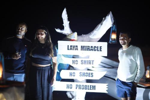 a group of three people standing in front of a sign at Laya Safari Resorts & Spa in Yala