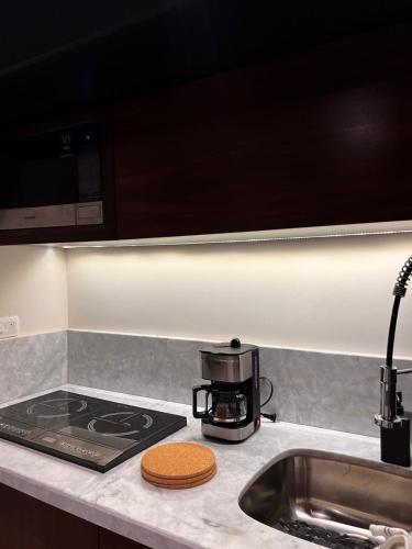 a kitchen counter with a coffee pot on a stove at Mya Black Diamond 202 in Playa del Carmen