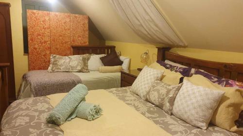 a bedroom with two beds with stuffed animals on them at Century House B & B flatlette in Oamaru