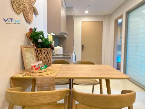 a wooden table and chairs in a room at The Song Vung Tau Homestay - VTLand in Vung Tau