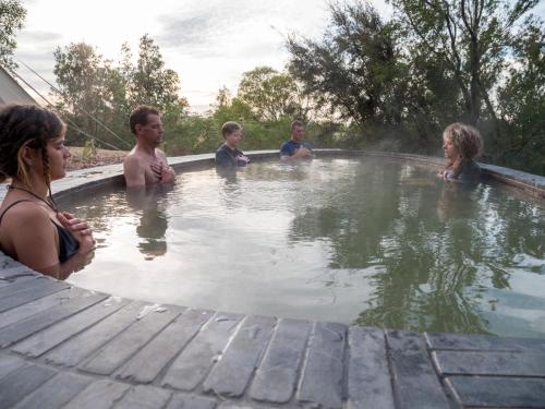 a group of people standing in a hot tub at Metung Hot Springs in Metung