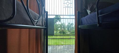 a view from a bunk bed looking out a window at Amaretto & Caffe Hostel in Surat Thani