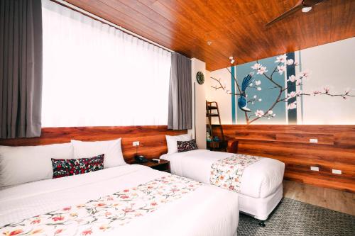 a hotel room with two beds and a painting on the wall at Hotel Kimberly Tagaytay in Tagaytay