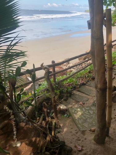 a fence on the beach with the ocean in the background at El Marabu Chill'n Surf in Aposentillo