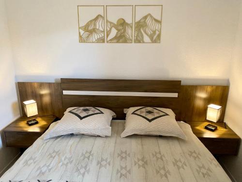a bedroom with two beds and two nightstands at Les Cristallines - Appartement Cosy in Orcières