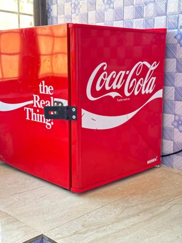 a coca cola cooler sitting on top of a table at Paje Home in Paje