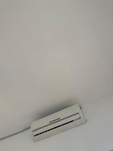 a ceiling with a white air conditioner at Paje Home in Paje